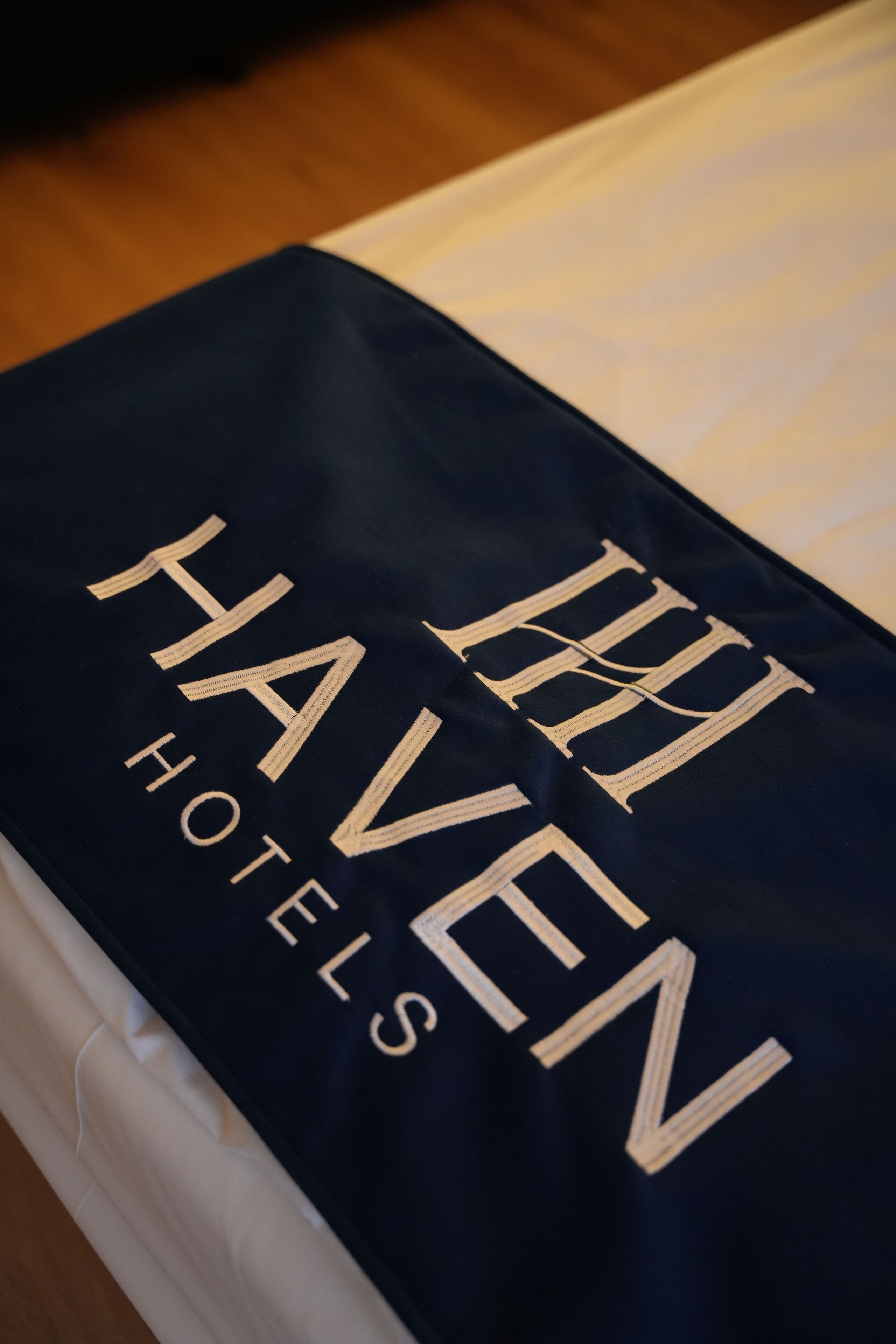 A dark blue hotel sign with the name "The Haven Hotels" in gold lettering.