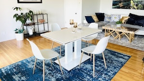 A modern living room with a dining area, featuring a white sofa set, a coffee table, and a large world map on the wall. - West Hollywood, Hollywood Hills, Sunset Strip House with Beautiful Views (Beverly Hills)