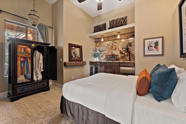 A bedroom with a large bed, a wardrobe, a mirror, and a decorative wall. - PRIVATE RESORT RETREAT - Pool, Hot Tub, Sauna & Games (Gilbert)