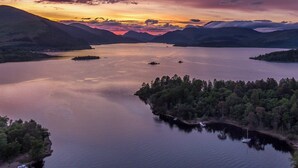 A serene lake surrounded by mountains during sunset. - Leven Lodge 1 - UK46042 (Loch Lomond)