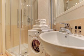 Shower, hair dryer, towels, shampoo