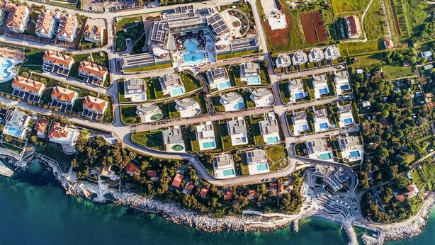 An aerial view of a coastal resort with multiple buildings, swimming pools, and a marina. - Beach front home in Savudrija (Savudrija)