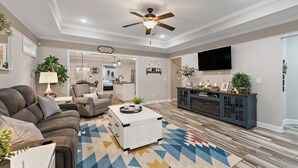 A modern living room with a sofa, coffee table, and TV.