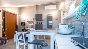 A modern kitchen with a white countertop, a large sink, and a built-in oven. - Comfortable attic located on the third and last floor of a building without a lift.It comfortably accommodates two people in 40 m2 of space with a double bedroom.Small building with a green space and ample free parking in front of the house, near the cen (Parma)