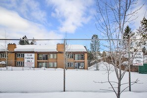 A fenced building with a sign indicating 'Club Parking Only' and 'No Trailers'. - Double Take Condo - Aspen Village - Golf - Shared Pool, Hot tub, Sauna, Gym, Courts (McCall)