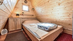 A cozy wooden cabin room with a single bed, a small cabinet, a radio, and a window. - Awesome home in Lovinac (Lovinac)