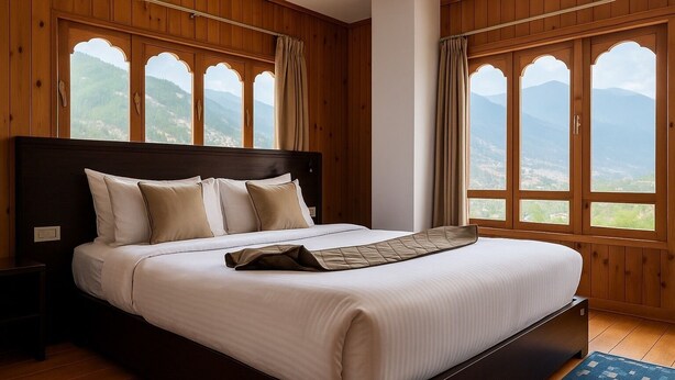 A large bed with a dark headboard, white bedding, and a view of mountains through arched windows. - Norbu Healing Hotel (Thimphu)
