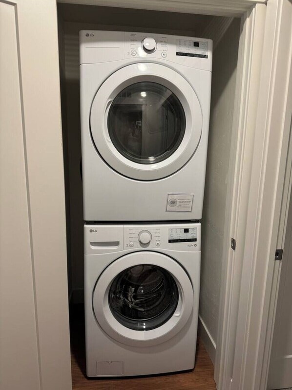 Una lavadora y secadora apiladas en un cuarto de lavado.