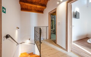 Step up to a stylish retreat with a staircase leading to an outdoor area and a glass door.