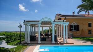 A pool area with a pergola, outdoor furniture, and a view of the countryside. - Awesome home in Castel Colonna di Mont (Castel Colonna di Mont)