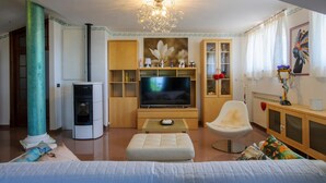 A modern living room with a fireplace, a television, and a comfortable seating area. - Awesome home in Castel Colonna di Mont (Castel Colonna di Mont)