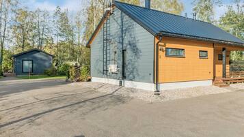 A two-story building with a metal roof and a wooden door.