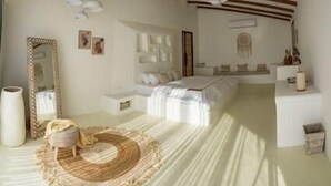 A bedroom with a bed, bedside tables, a mirror, and a decorative rug.