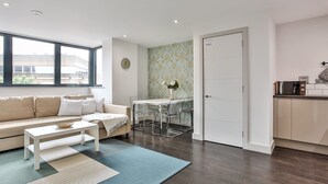 A modern living room with a sofa, coffee table, and dining table. - 2 Bedroom Self-Contained Flat - 2 beds, 2 baths (Sheffield)