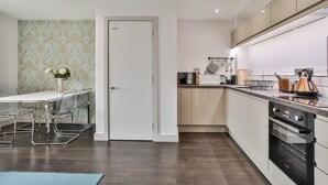 A modern kitchen with a built-in oven, a kettle, and a coffee machine. - 2 Bedroom Self-Contained Flat - 2 beds, 2 baths (Sheffield)