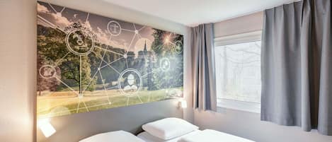 A hotel room with two beds, a nightstand, a wall-mounted artwork depicting a landscape with icons, and a window with curtains.