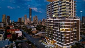 A multi-story hotel with balconies, located in a cityscape with other high-rise buildings. - New apartment, spectacular views day and night. Close to everything!! (Surfers Paradise)
