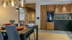 A modern kitchen with wooden cabinets, a built-in microwave, and a sink.