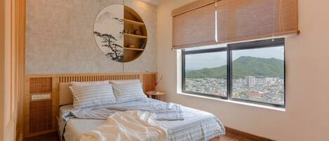 A bedroom with a bed, a wall-mounted shelf, a window with a view of a cityscape, and a ceiling light.