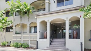 A building with a covered entrance, a staircase leading to the entrance, and a sign indicating 'Building 8'. - Cairns One Resort Style Living- Luxury Resort Apartment | 9 Pools | Near CBD & Esplanade (Westcourt)