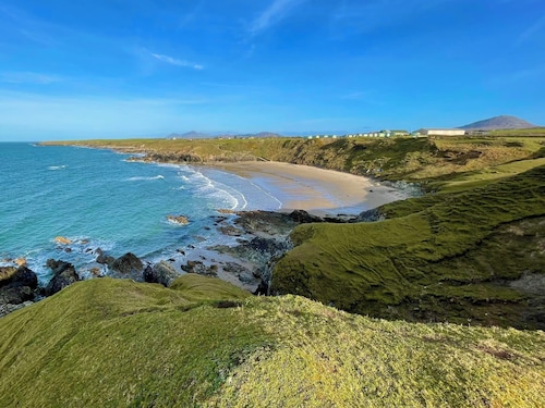Escape to our charming stone cottage in South Wales, a rustic retreat perfect for couples. Enjoy a cozy stay with a stone fireplace, a king-sized bed, and a private, enclosed garden perfect for pets. Conveniently located near Bridgend and  Porthcawl.
