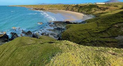 Escape to our charming stone cottage in South Wales, a rustic retreat perfect for couples. Enjoy a cozy stay with a stone fireplace, a king-sized bed, and a private, enclosed garden perfect for pets. Conveniently located near Bridgend and Porthcawl.
