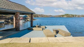 A waterfront patio with outdoor seating and a covered area. - Magnolia Tides- Incredible Views @ Lake Tuscaloosa (Northport)