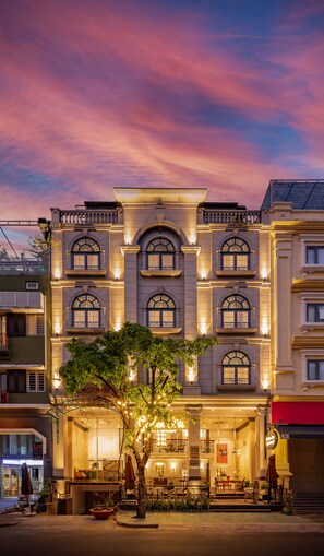 A multi-story hotel with a classic architectural style, featuring arched windows and a balcony. - Golden Star Hotel & Apartment (Ho Chi Minh City)