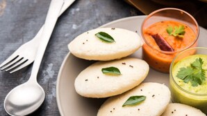 A plate with idlis, a bowl of sambar, and a bowl of chutney. - Srinidhi Residency (Bengaluru)