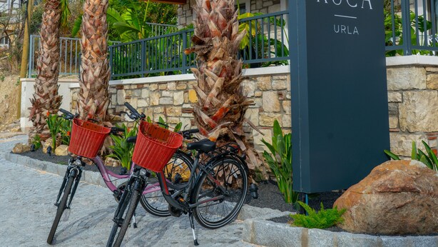 A building with a sign reading "KUÇA URLA" and a bicycle parked in front. - KUCA URLA (Urla)