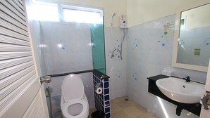 Un baño con inodoro, ducha y lavamanos.