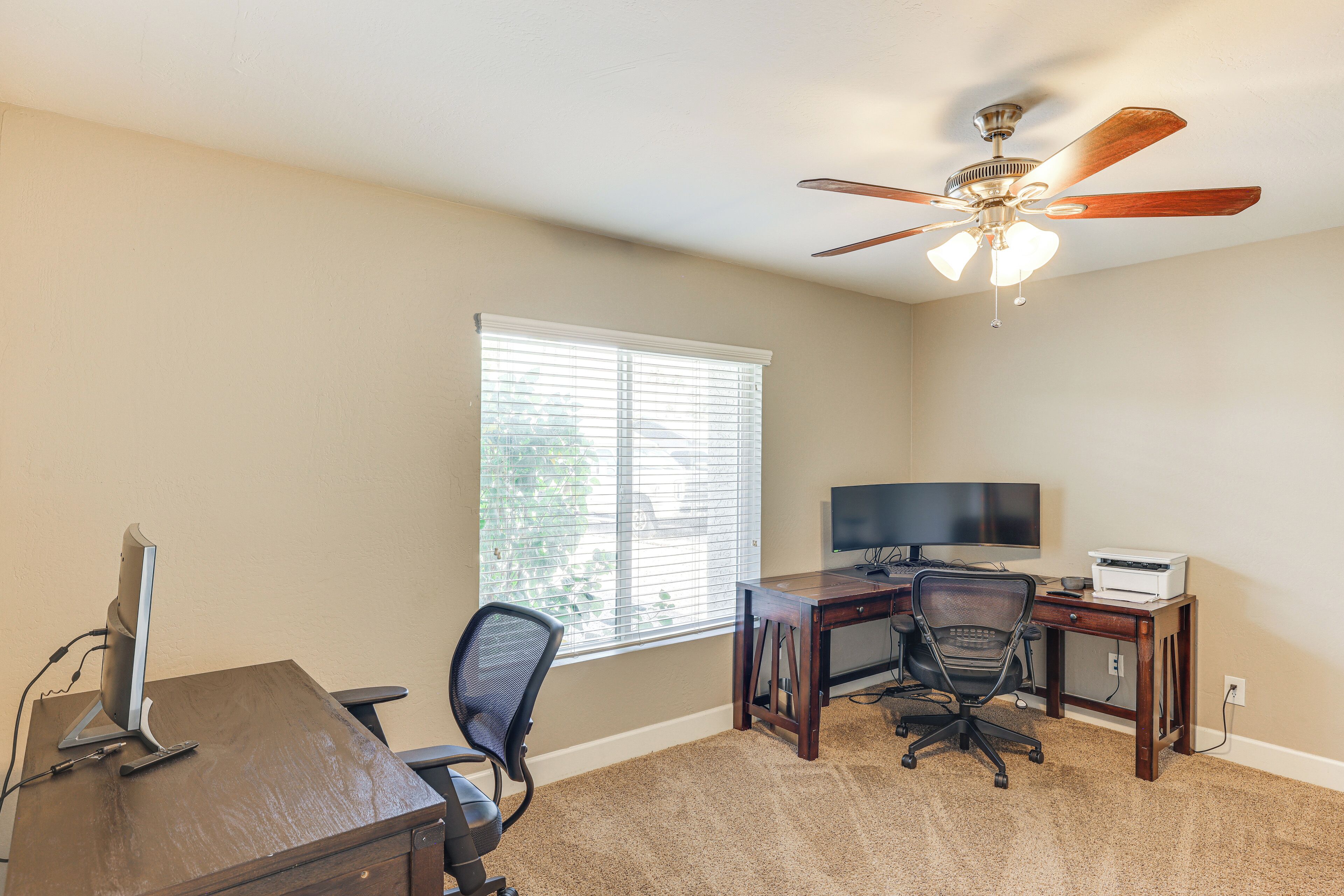 A home office with a desk, computer, and office chair.