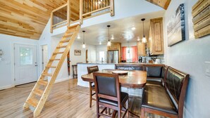 A spacious kitchen with wooden cabinets, a central island, and a built-in bench. - Waterfront Home: Allegheny River Access, Dock Slip (Ford City)