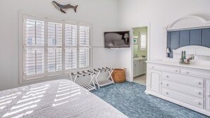 A bedroom with a bed, a TV, a dresser, and a window with shutters. - Walk to Beach: Home w/ Pool Access in Myrtle Beach (Myrtle Beach)