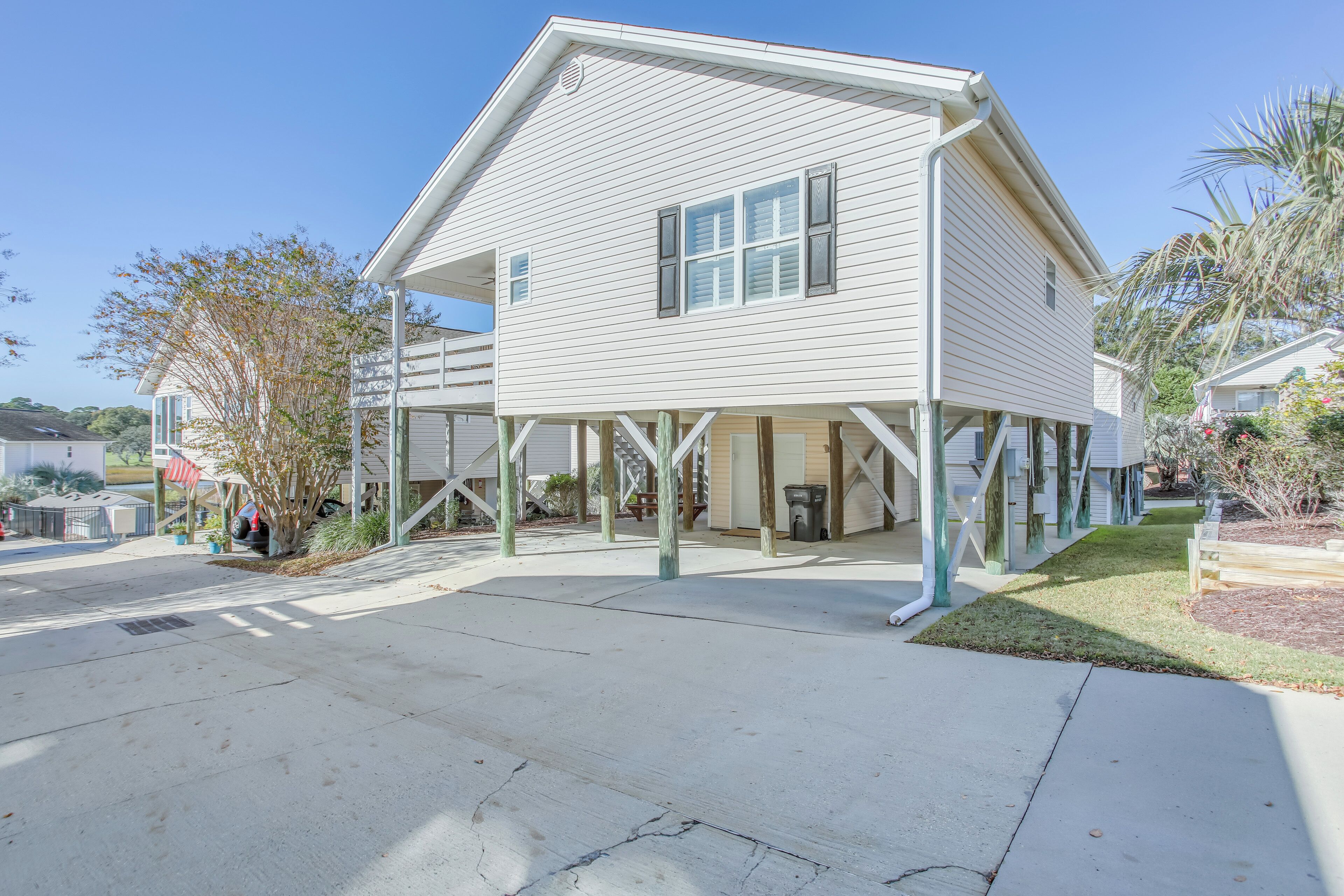A two-story house with a covered porch and a garage.
