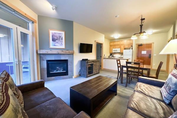 Open living room with gas fireplace.