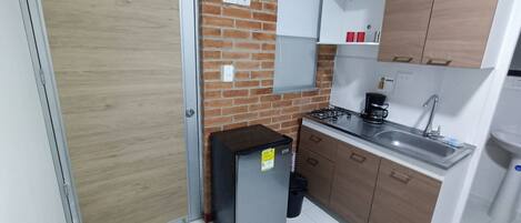 Fridge, microwave, coffee/tea maker, cookware/dishes/utensils