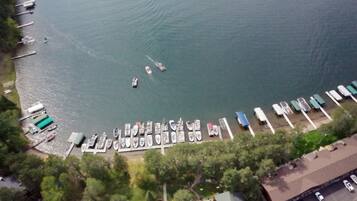 An aerial view of a marina with numerous boats docked and a few in the water.