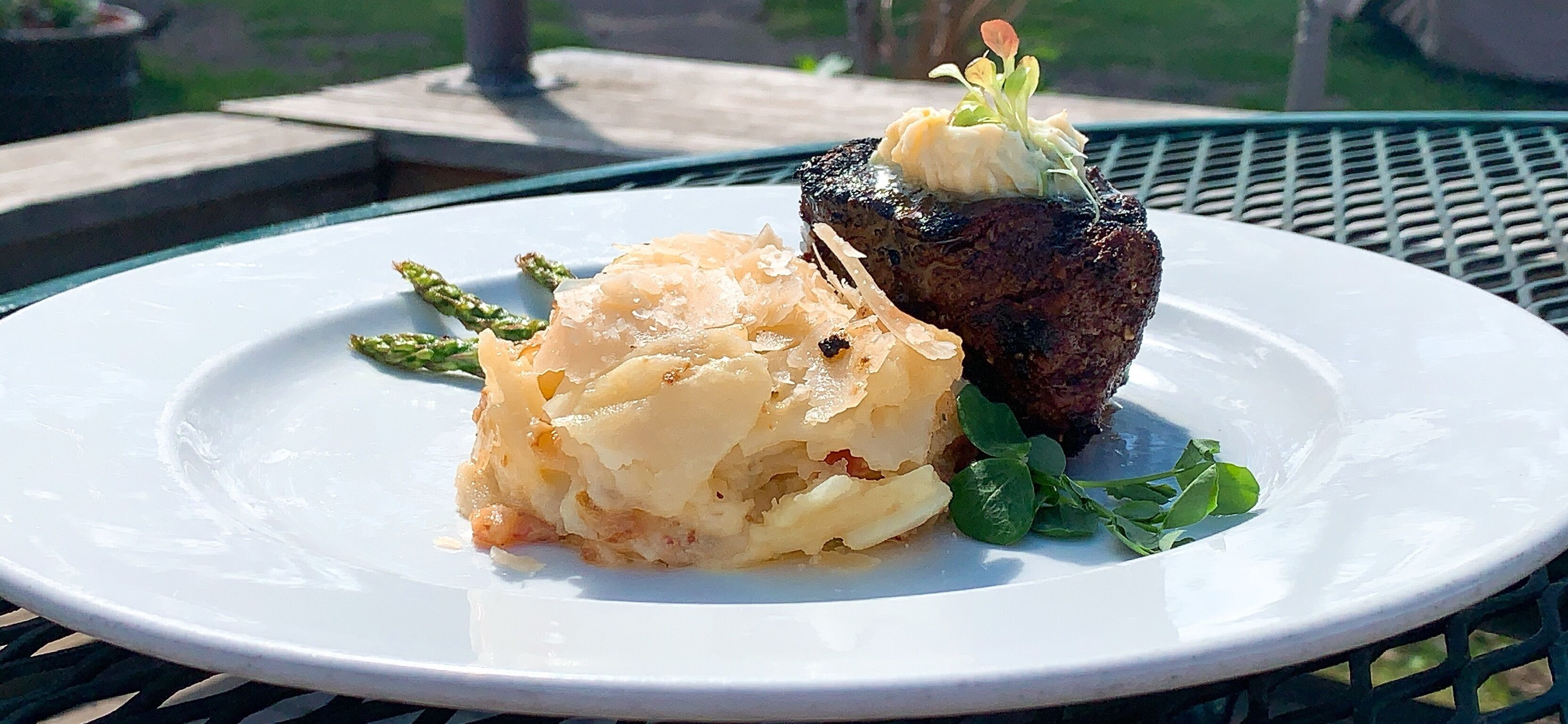 Een bord met steak en aardappelpuree.