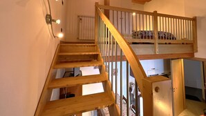 A wooden staircase with a loft bedroom above. - San Simone rentals - VALS30 (Valleve)