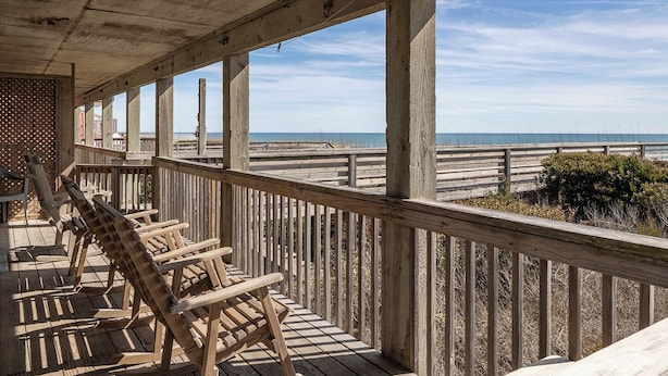 A wooden deck with a view of the ocean. - Sassy Seagull West, Oceanfront Duplex in Emerald Isle, NC! (Emerald Isle)