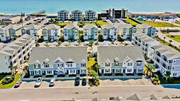 A coastal hotel with multiple-story buildings, a parking lot, and a view of the ocean. - Seaside Villas 44, Soundside Townhouse in Atlantic Beach, NC! (Atlantic Beach)