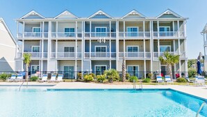A multi-story hotel with a pool in front. - Seaside Villas 44, Soundside Townhouse in Atlantic Beach, NC! (Atlantic Beach)