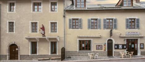 A two-story building with a ground-floor restaurant and upper-floor rooms.