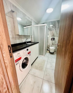 Deluxe Studio, City View | Bathroom | Shower, free toiletries, hair dryer, slippers