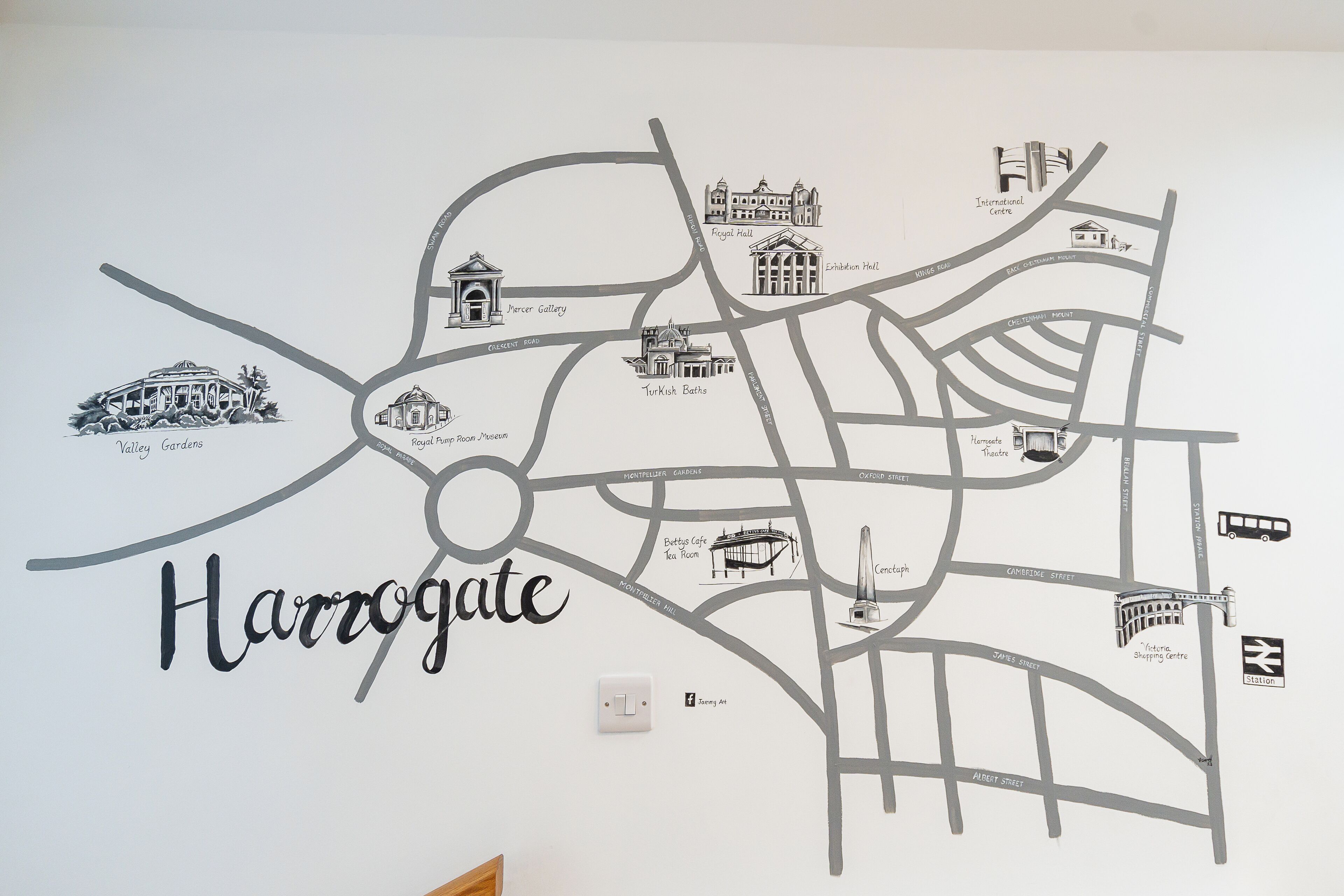 A wall map of Harrogate with labeled streets and landmarks like the Royal Pump Room Museum and Turkish Baths.