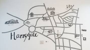 A wall map of Harrogate with labeled streets and landmarks like the Royal Pump Room Museum and Turkish Baths.