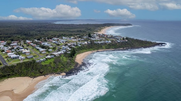 A coastal residential area with houses along the beach and ocean.