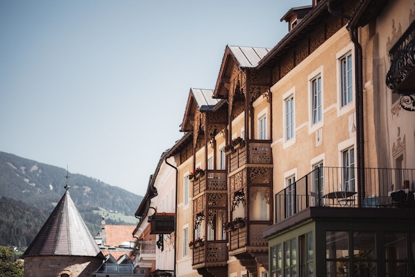 A traditional European building with ornate balconies and a steeply pitched roof.