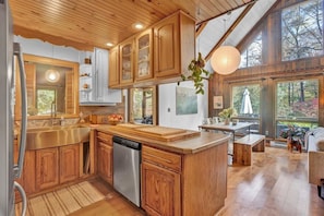 Enjoy cooking in this well-equipped kitchen with a large island, stainless steel sink, and ample counter space.